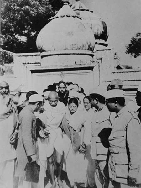 Gandhiji coming out from a mosque after inspecting the damages in it during the communal riot in Bihar, 1947.jpg
